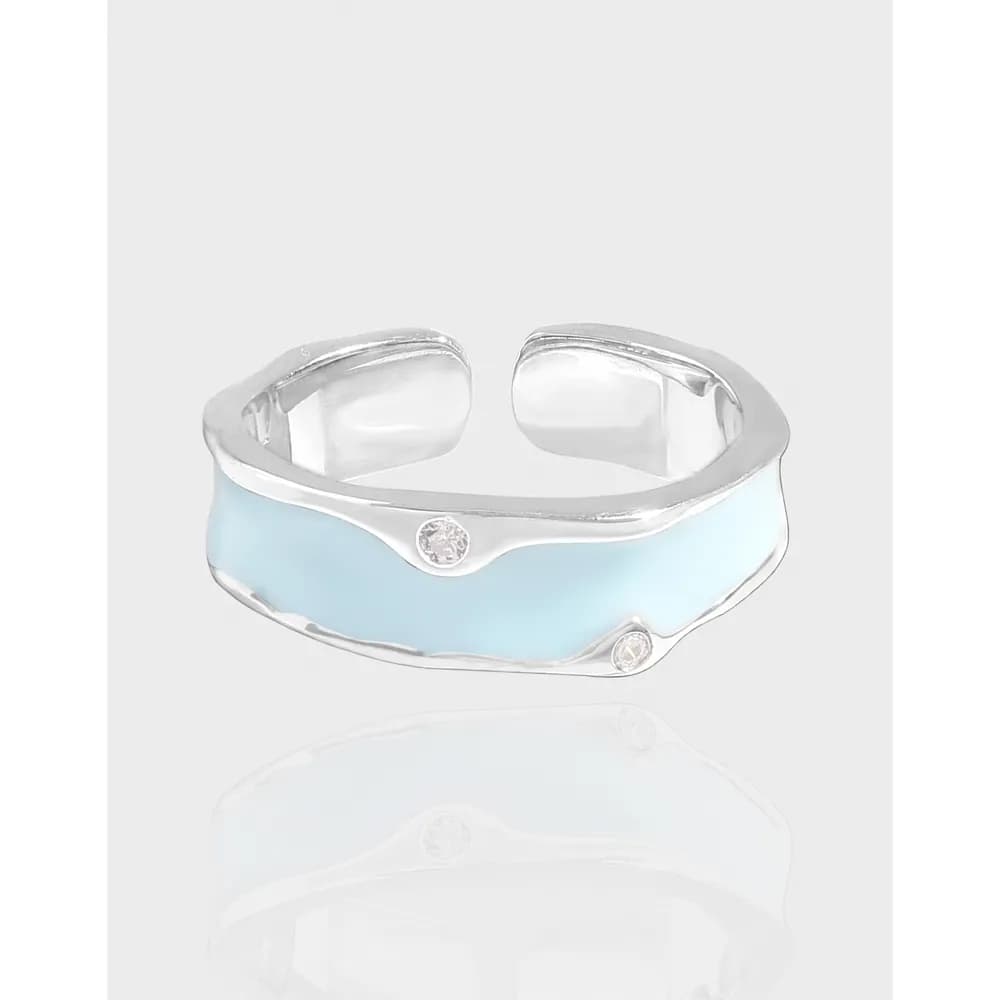 Open polished silver ring with a pale blue enamel band and two small stones on the band.