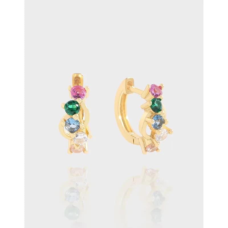 Polished gold-tone hoop earrings with multicolor stones arranged along a curved silhouette.