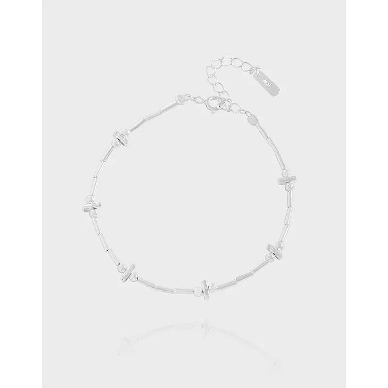 Polished sterling silver segmented bead bracelet with extender chain and clasp.