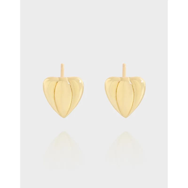 Polished sterling silver heart-shaped leaf earrings with posts on a light background.