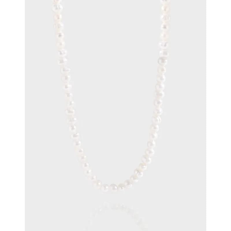 Strand of small white pearls on a polished sterling silver necklace