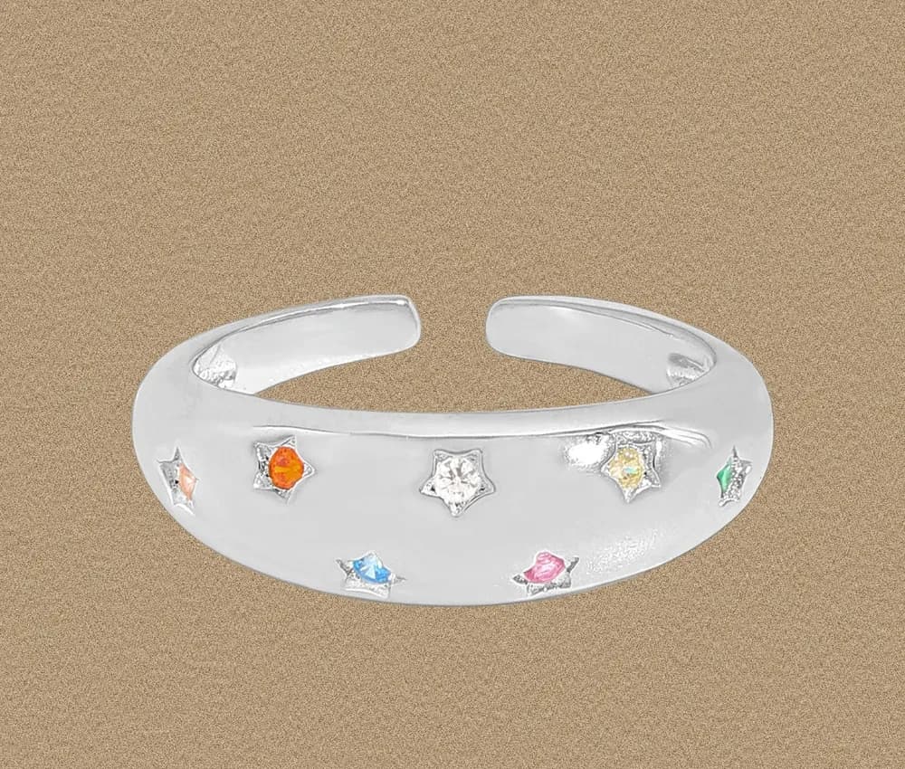 Open sterling silver cuff ring featuring star shapes and colorful stone accents along the band.