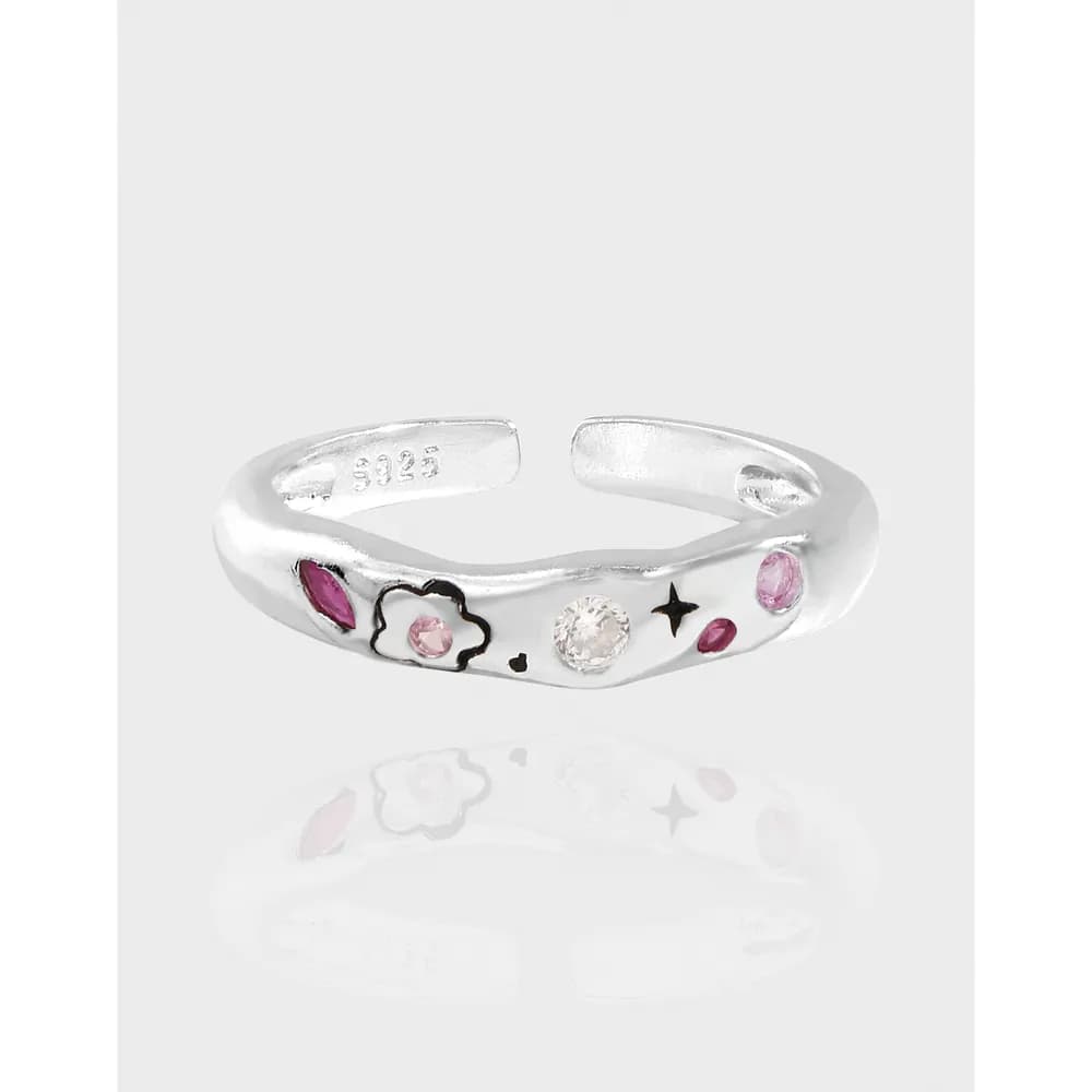 Open-ended sterling silver ring with pink stones and a flower outline motif