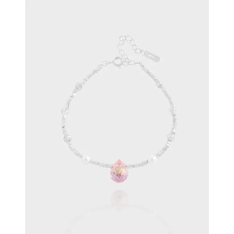 Sterling silver beaded bracelet with a pink teardrop pendant centerpiece and pearl accents on a delicate chain.