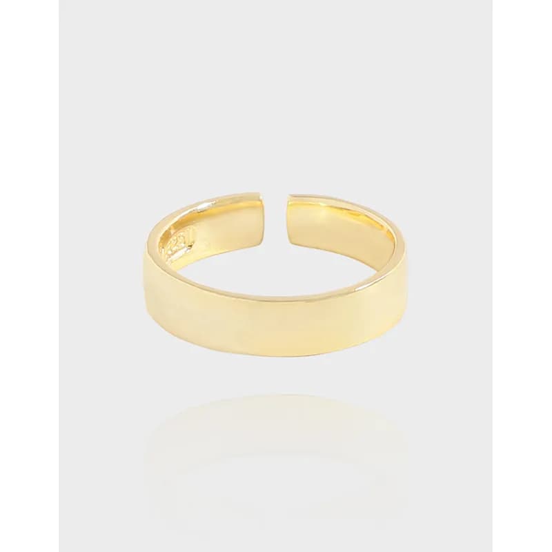 Polished wide sterling silver ring with an open back gap on a white background.