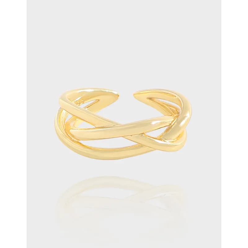 Polished sterling silver crisscross ring with two intertwined bands on a light background.