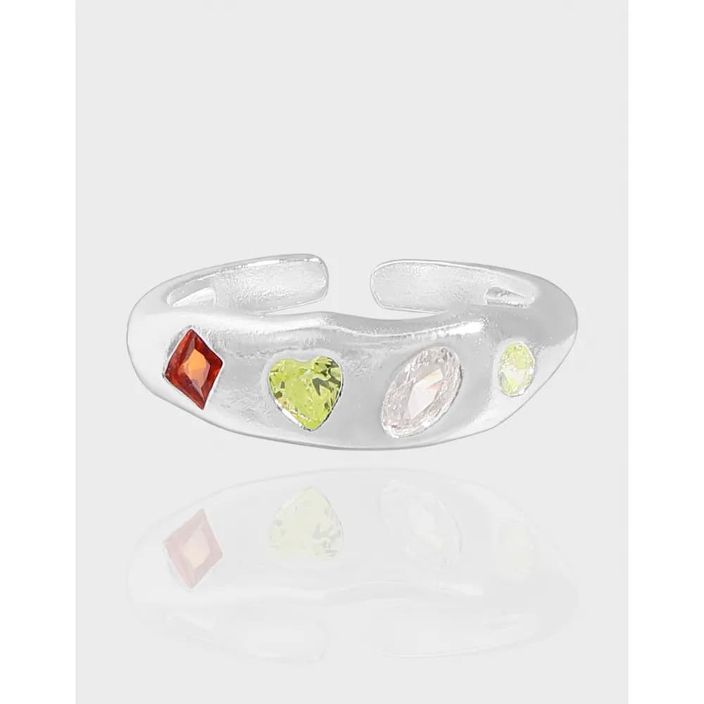Polished sterling silver ring with four colorful stones set along a curved band.