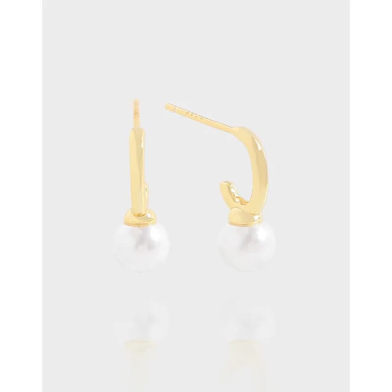 Polished sterling silver hoop earrings with pearl drops on a white background.