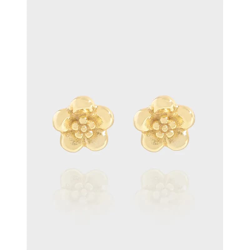 Pair of polished five-petal flower stud earrings with a subtle gold-tone center