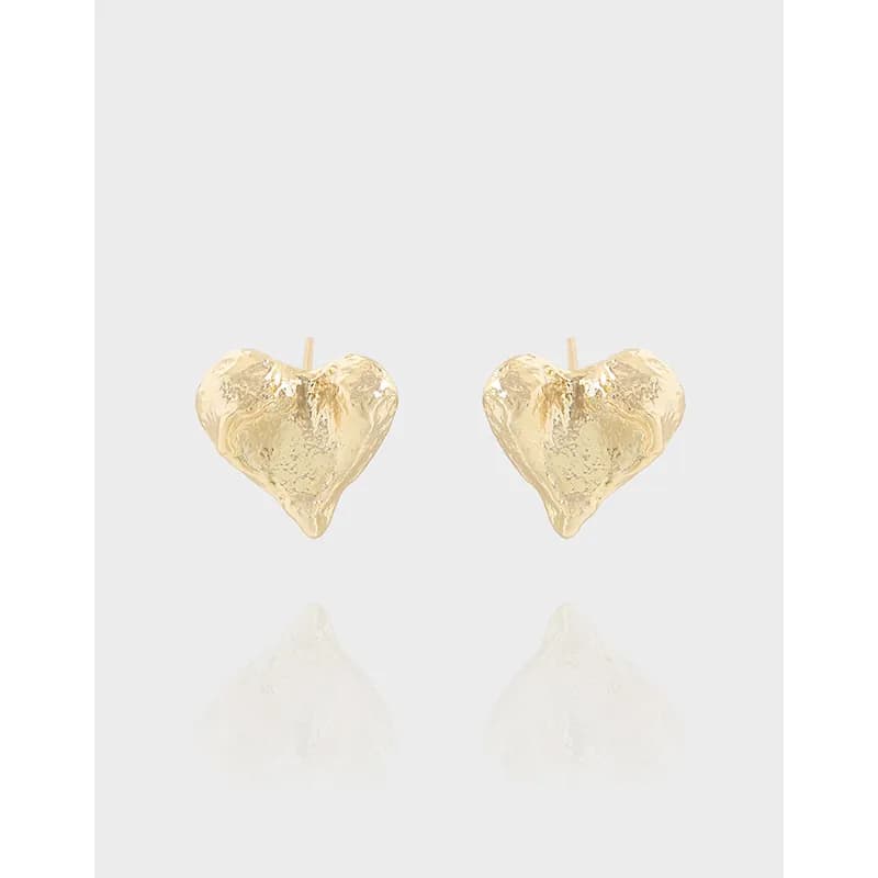Pair of heart-shaped textured stud earrings in a polished metal finish.