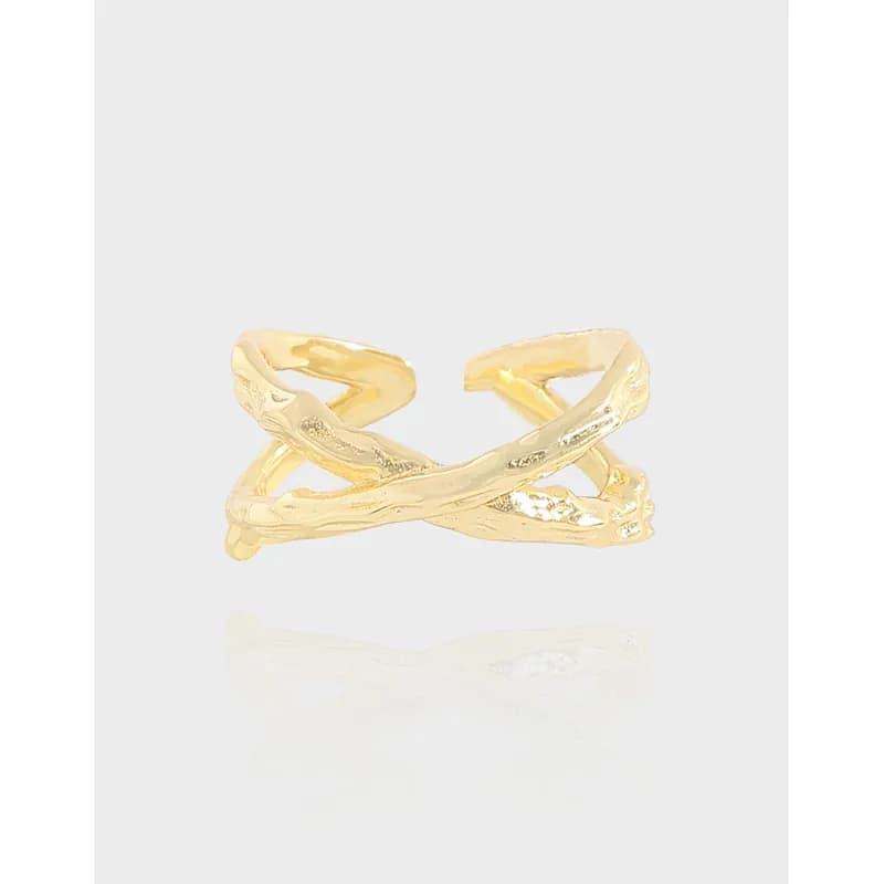 Polished sterling silver twisted branch ring with an open crossover design on a light background.