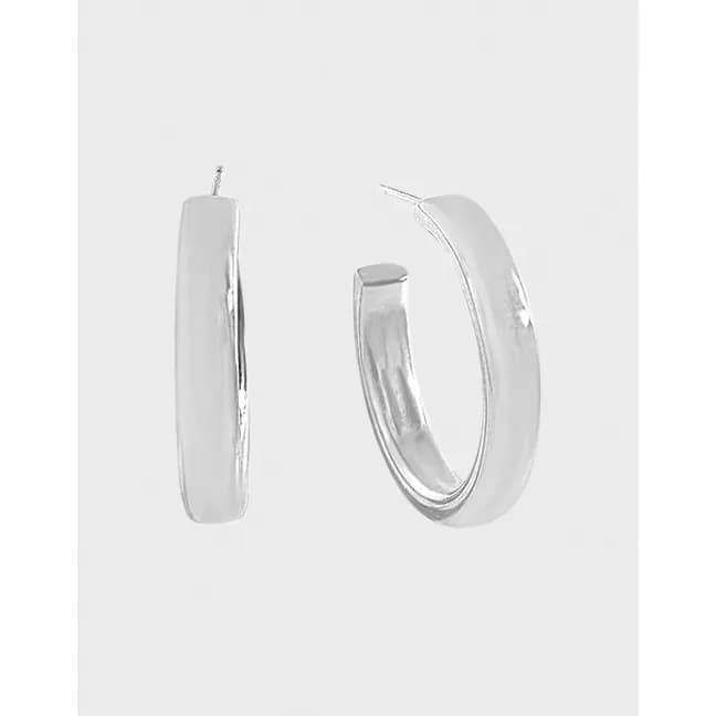 Polished sterling silver rectangular hoop earrings displayed on a light background.