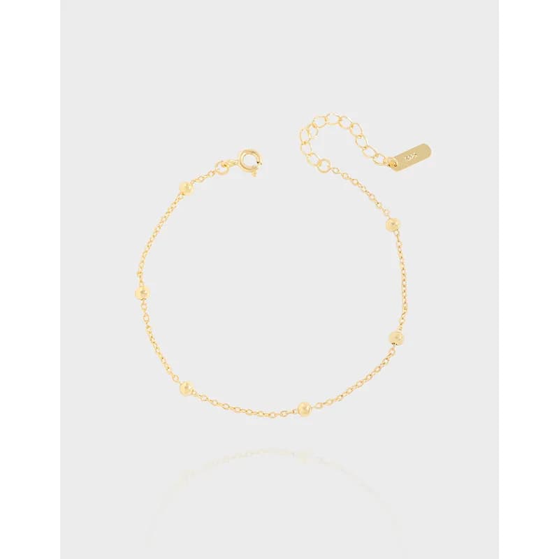 Delicate polished sterling silver bracelet with evenly spaced bead accents and an adjustable clasp