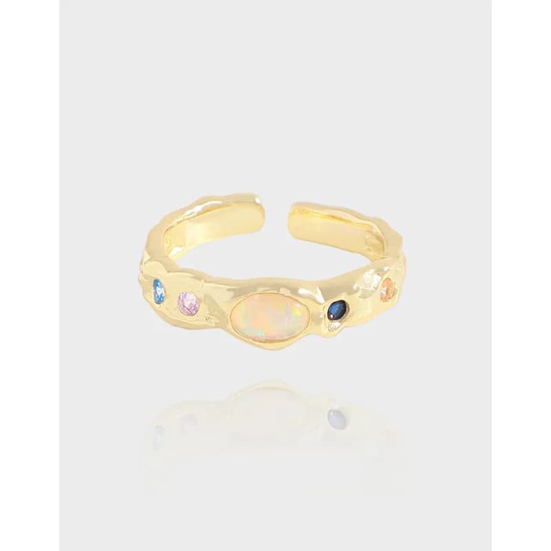 Polished sterling silver textured ring with an opal centerpiece and small colorful stones along the band.