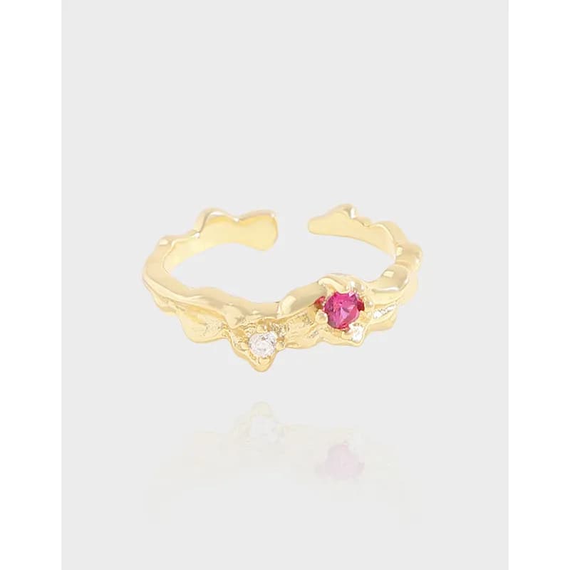 Polished sterling silver wavy ring with two small stones along the front.