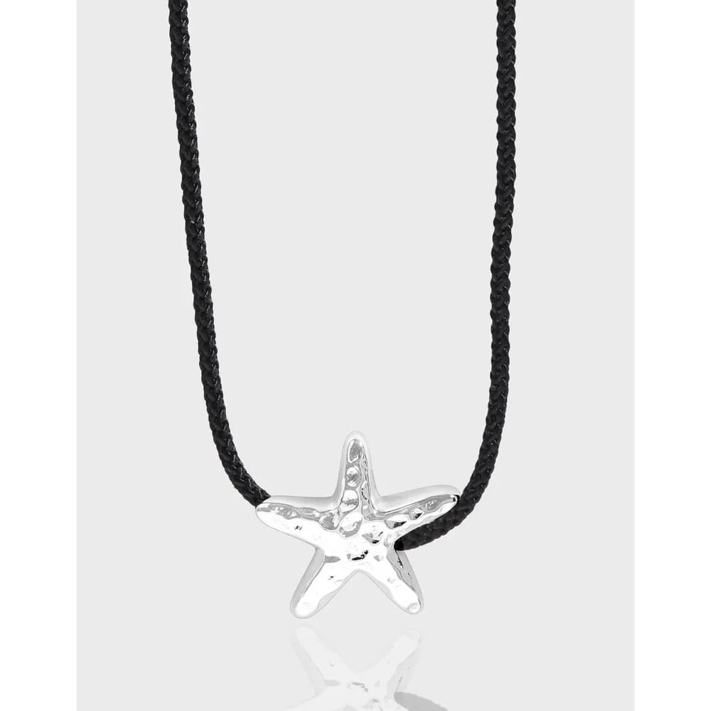 Sterling silver starfish pendant on a black braided cord necklace.