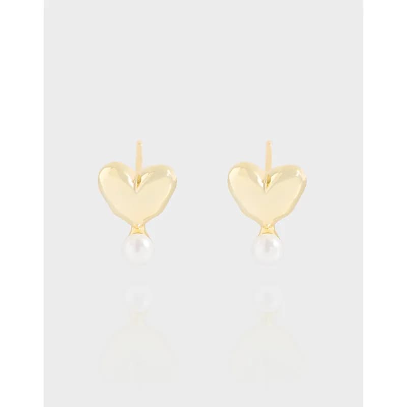 Pair of polished sterling silver heart earrings with pearl drops on a light background.