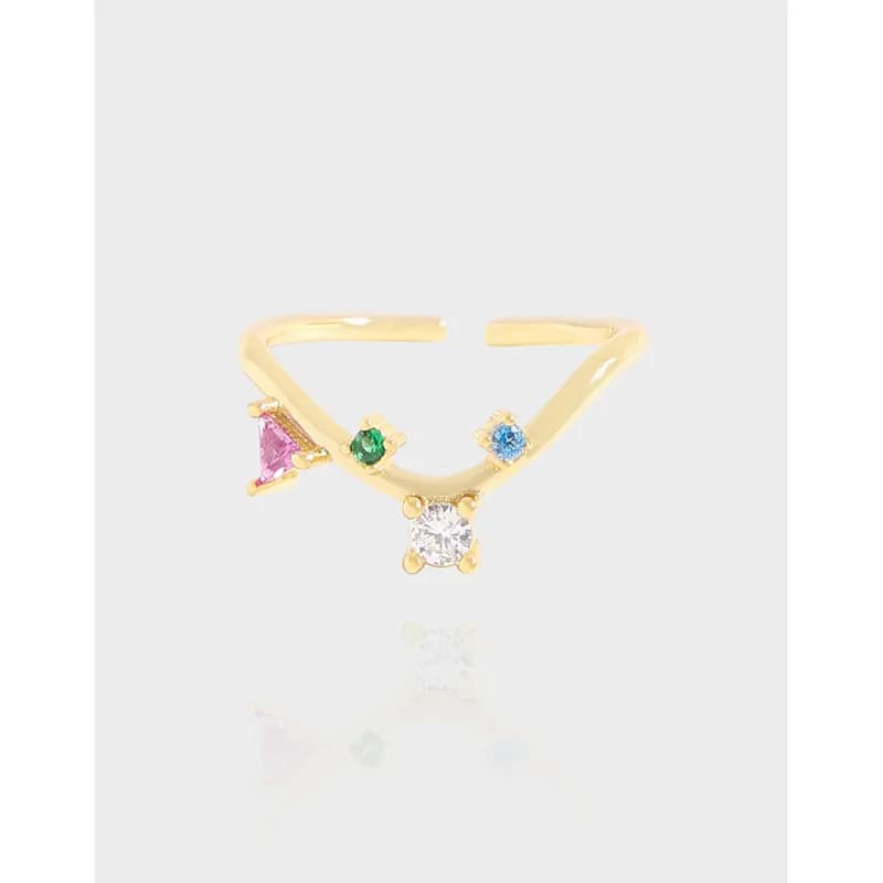 Open V-shaped sterling silver ring with pink, green, blue, and clear stones set along the curved band.