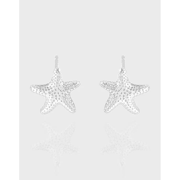Pair of sterling silver starfish earrings with a dotted texture and polished finish, hanging from small hooks.