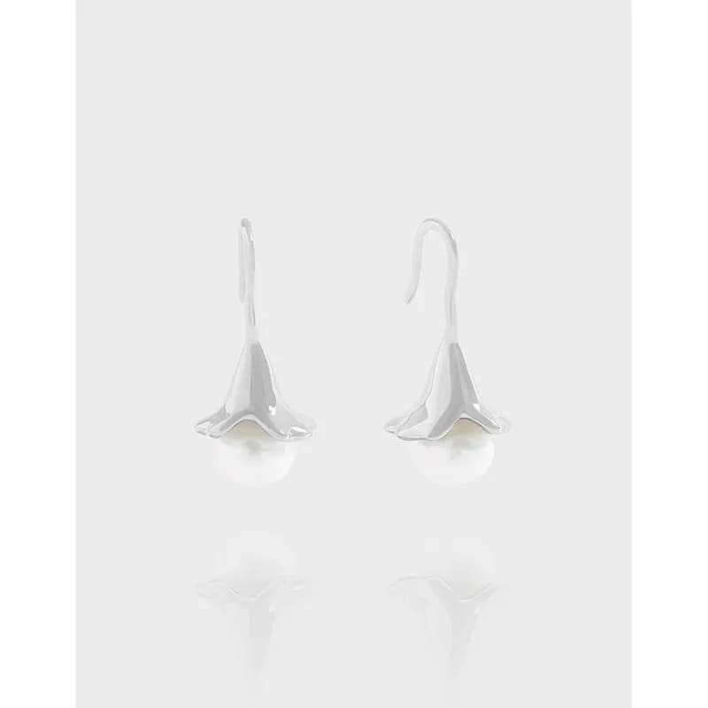 Polished sterling silver sail-shaped drop earrings with white pearls visible