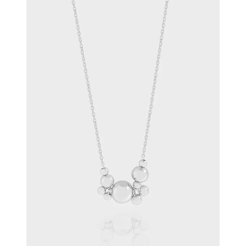 Polished sterling silver necklace with a multi-bead cluster pendant hanging at the center