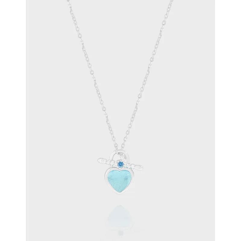 Sterling silver necklace with a turquoise heart pendant and blue accent gem on a delicate chain.