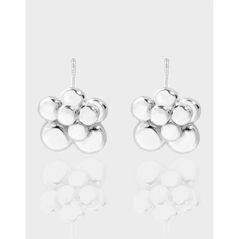 Pair of polished silver bubble cluster earrings hanging against a pale background.