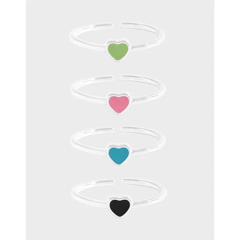 Four silver stacking rings with colorful heart enamel centers, arranged in a vertical line.