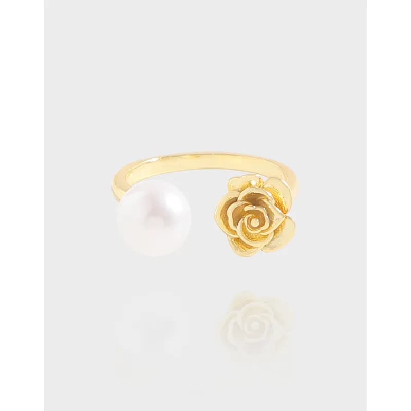 Open-band ring with a pearl bead on one side and a gold-tone rose on the other end