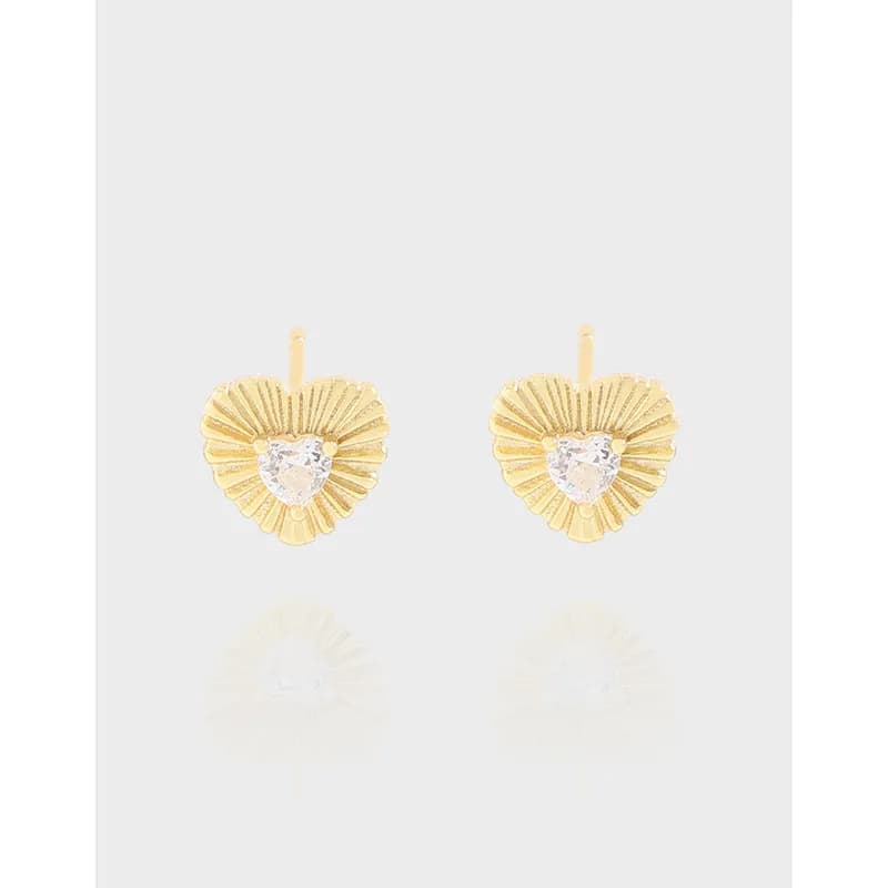 Pair of heart-shaped sunburst stud earrings with a clear central stone and radiating textured spokes.