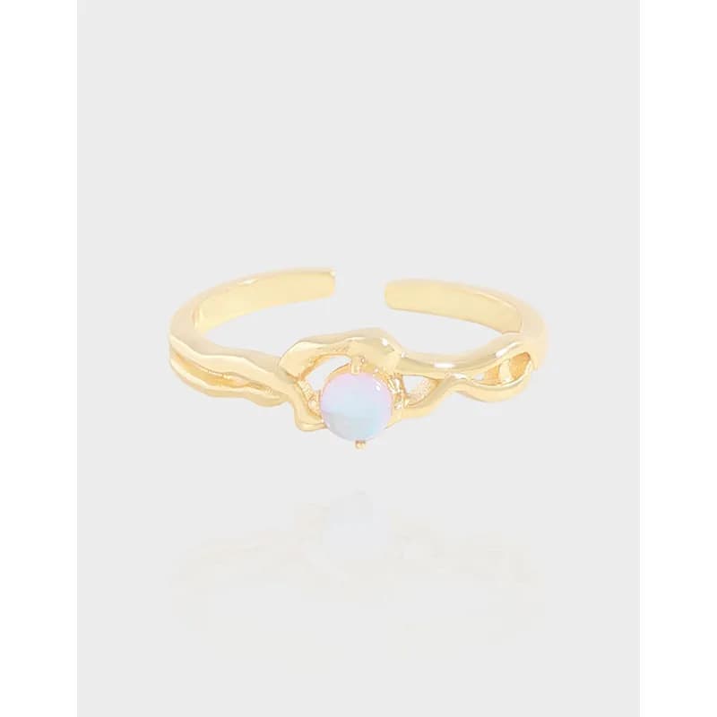 Polished sterling silver ring with a wavy open band and a small iridescent opal cabochon at the center.