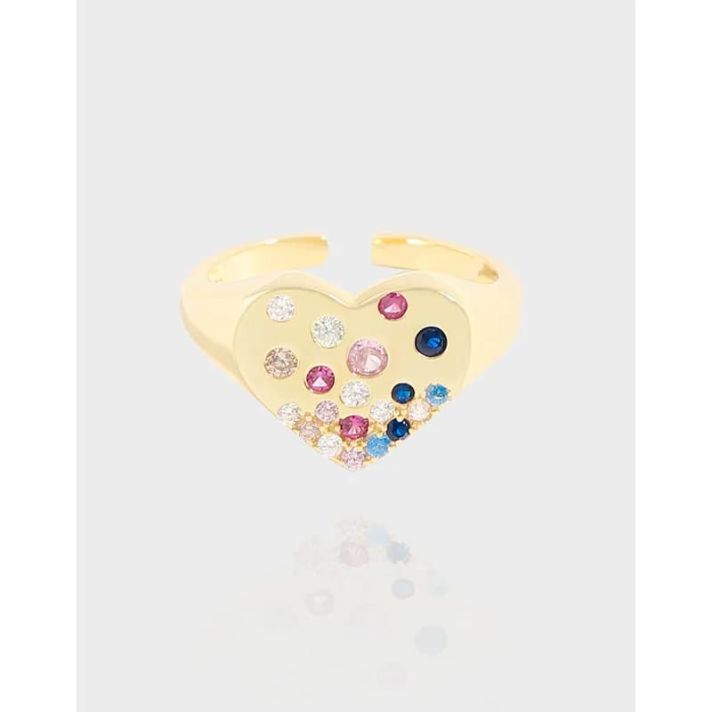 Polished sterling silver heart-shaped ring with a colorful gemstone cluster on the heart face.