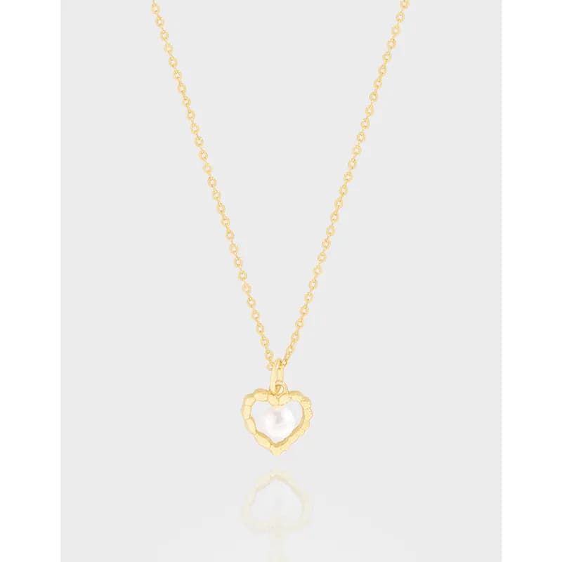 Delicate gold-tone heart pendant on a fine chain with a scalloped-textured heart frame and white center.