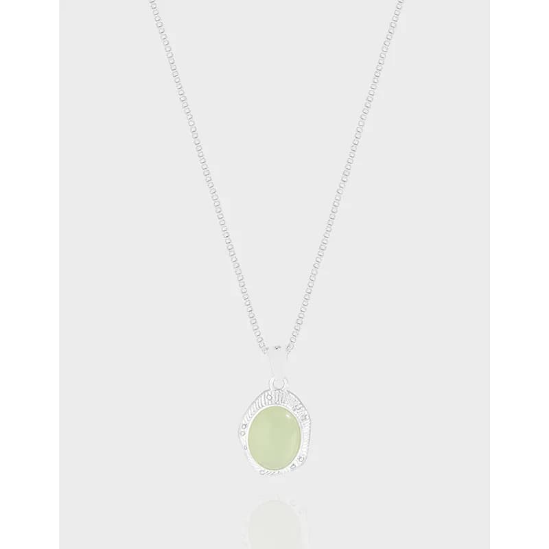 Sterling silver necklace with an oval pale green pendant on a fine chain.
