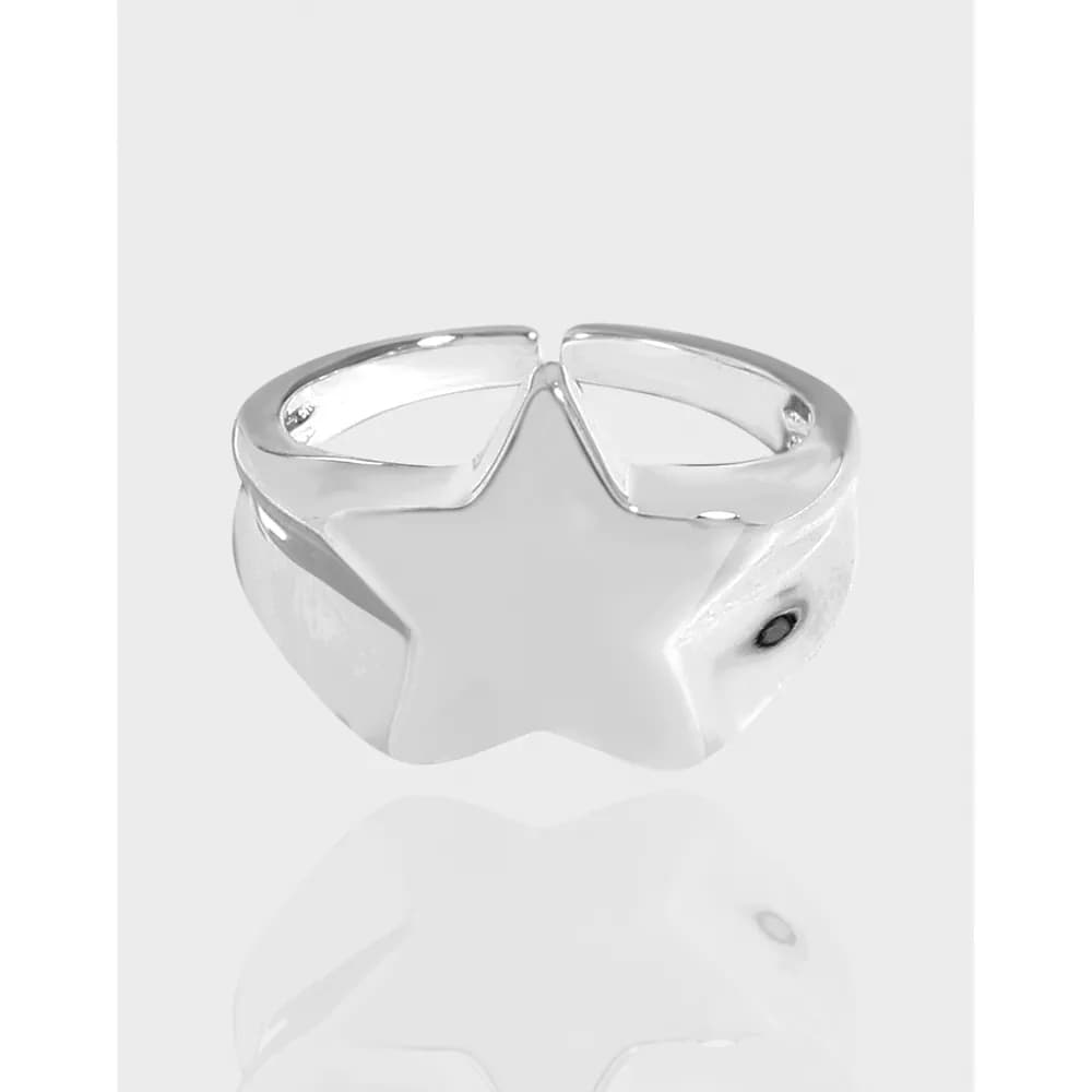 Polished sterling silver ring with a prominent star cutout motif on the top