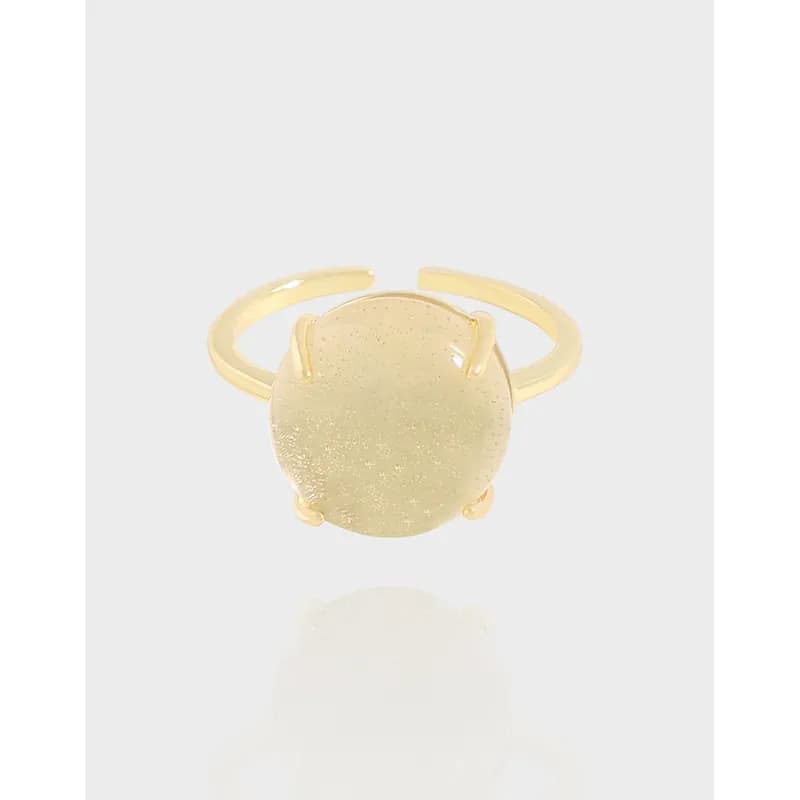 Polished round disc ring with a flat textured centerpiece on a slim, open band.