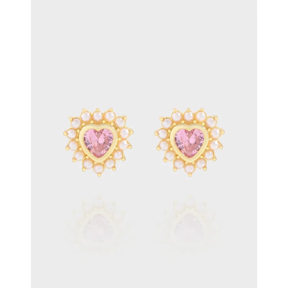 Pair of heart-shaped earrings with pink center stones surrounded by a pearl halo