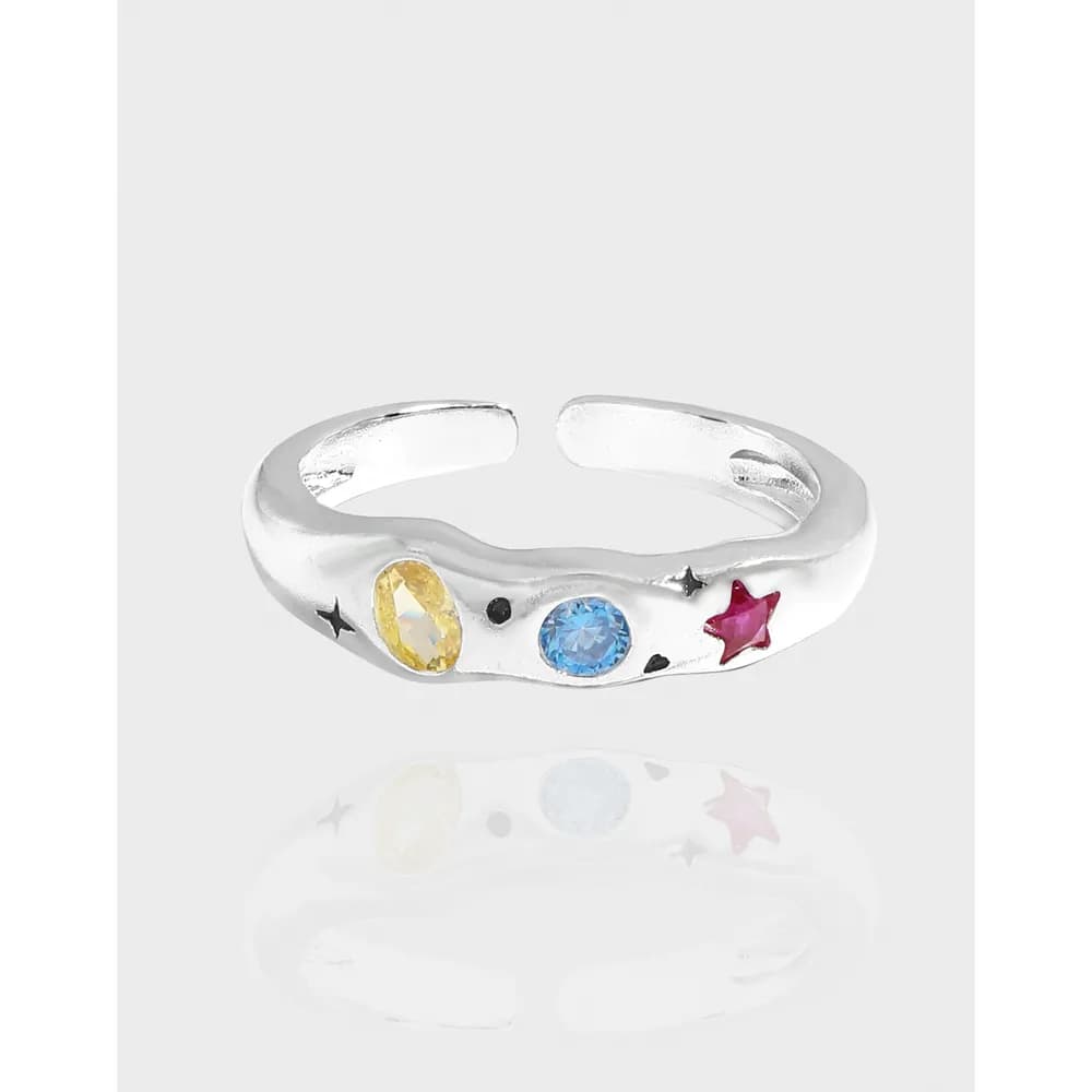 Polished sterling silver open-band ring with colorful stones and star motif on the side.
