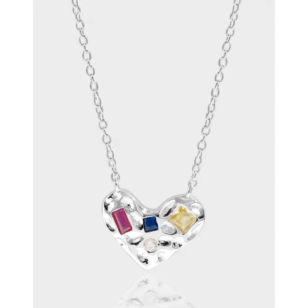 Polished sterling silver heart pendant with colorful gemstone accents on a silver chain.