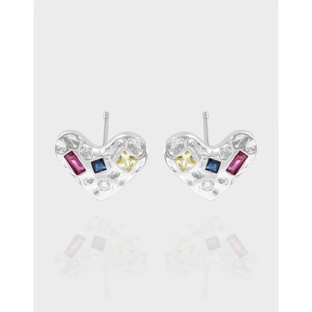 Two polished sterling silver heart-shaped earrings with colorful gemstone inlays on a light background.