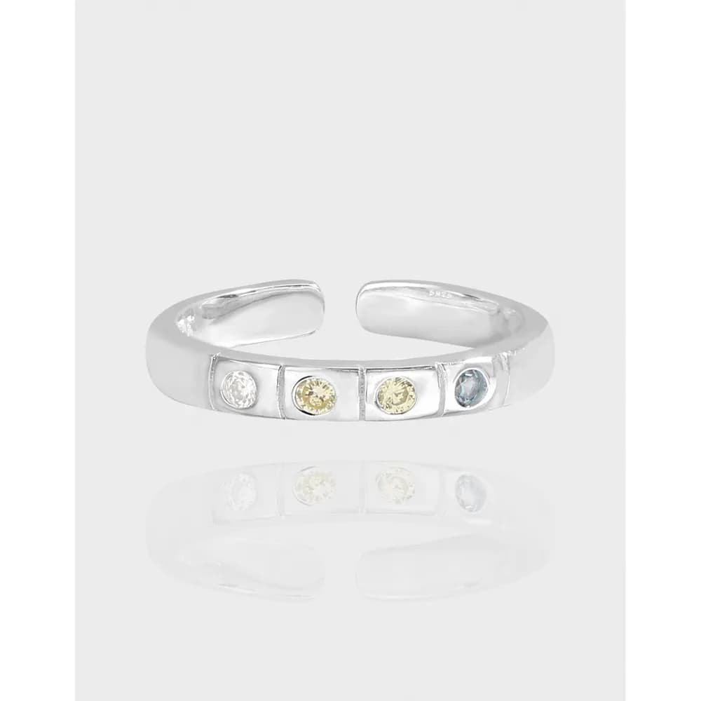 Polished sterling silver open-band ring with five bezel-set stones in a row