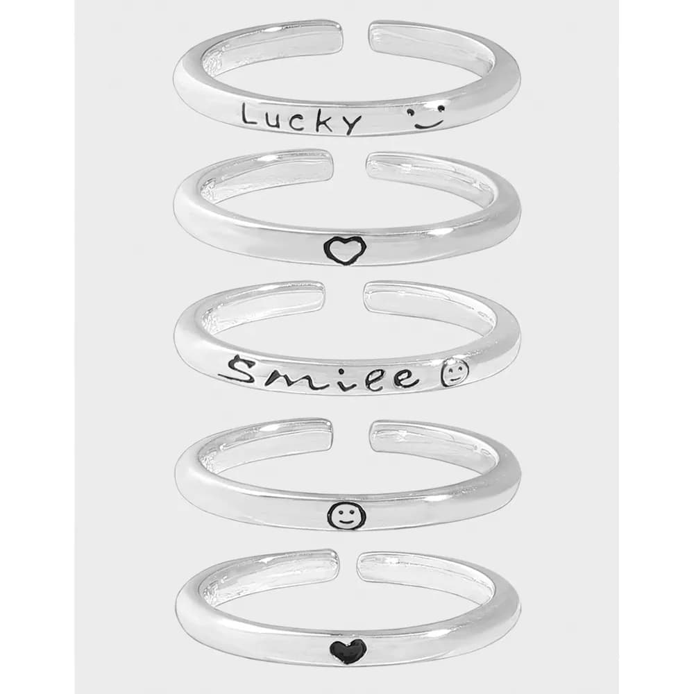 Polished sterling silver open cuff earrings stacked with Lucky, smile, and heart motifs.