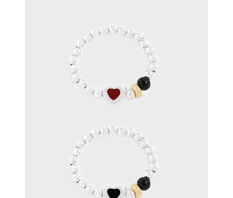 Sterling silver beaded ring with a heart enamel charm and accent beads on the front.