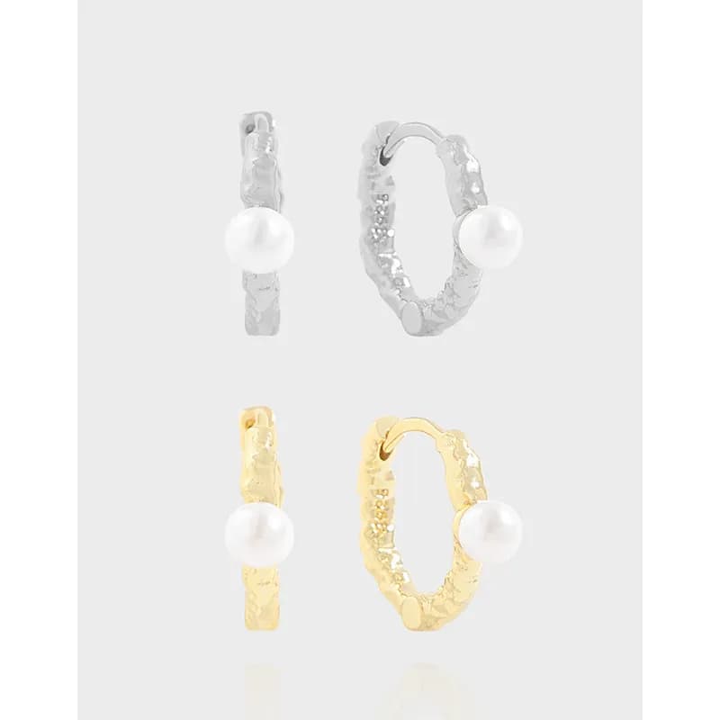 Textured hoop earrings with a single pearl accent in silver and gold finishes