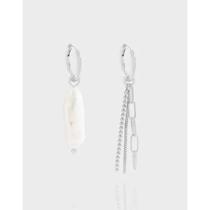 Sterling silver earrings, one with a pearl drop and the other with dangling chain embellishments, shown against a light background.
