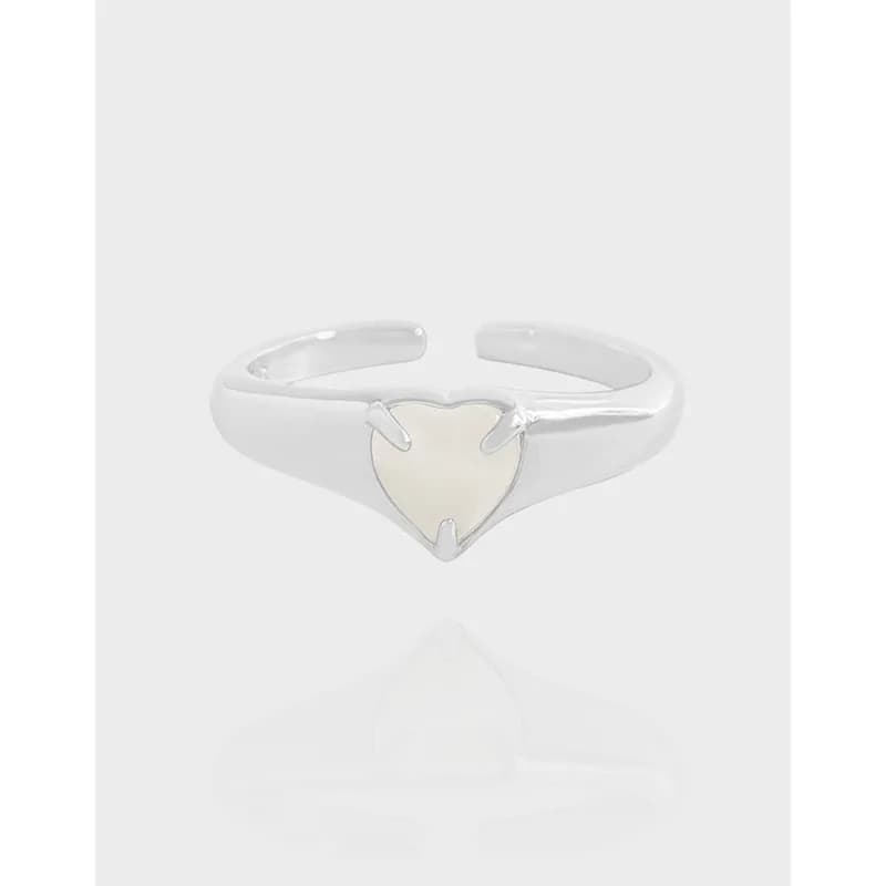 Polished sterling silver open ring with a pale gold heart centerpiece and minimalistic design.