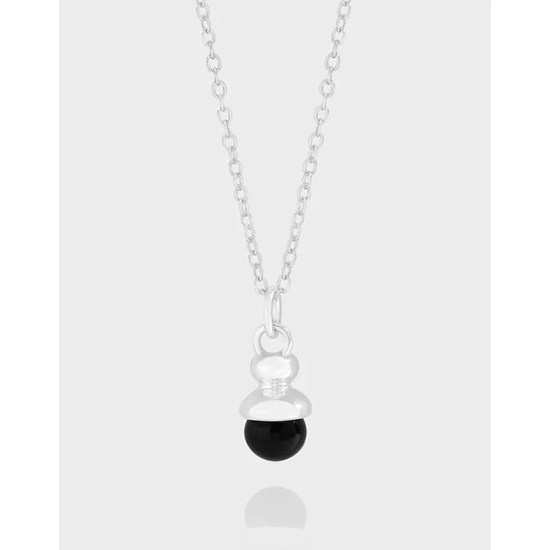 Sterling silver chain with a three-bead pendant in clear and black.