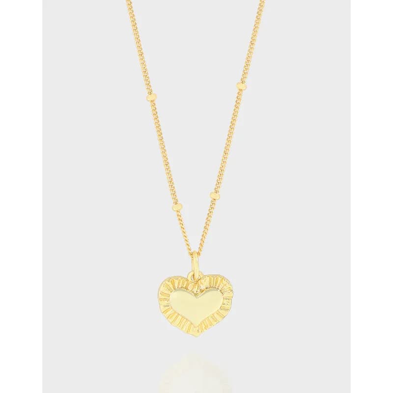 Polished sterling silver heart pendant necklace with a textured border on a slim chain