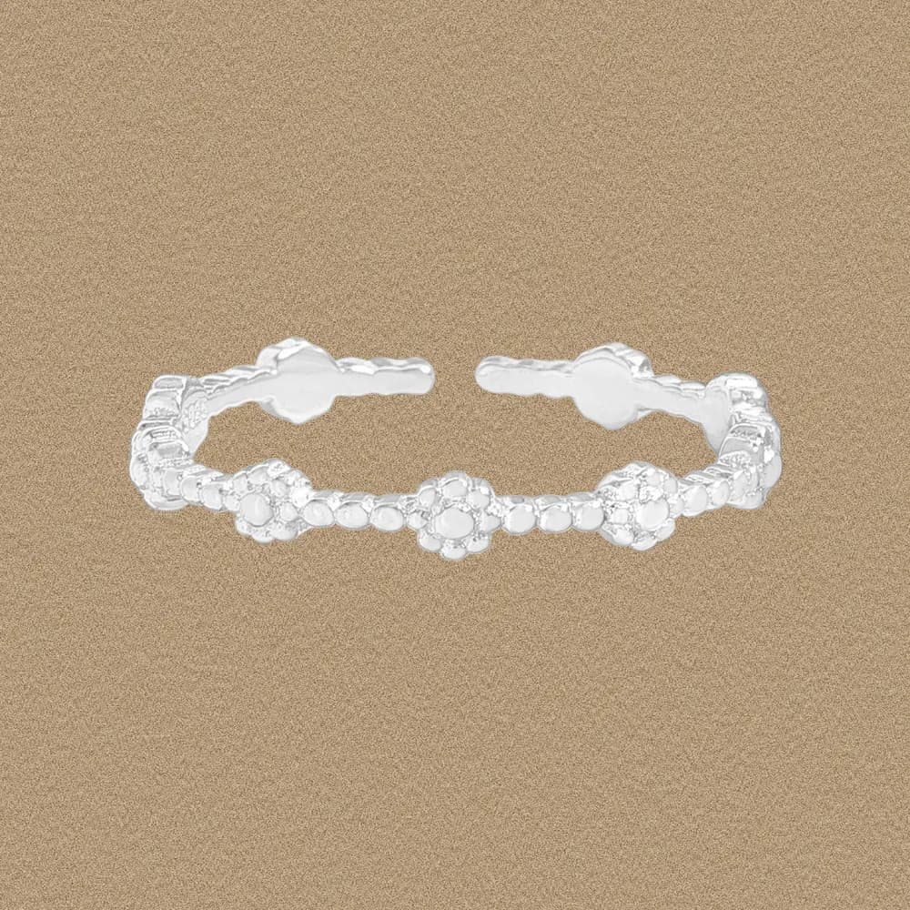 Sterling silver beaded ring with small flower-like clusters on an open band.