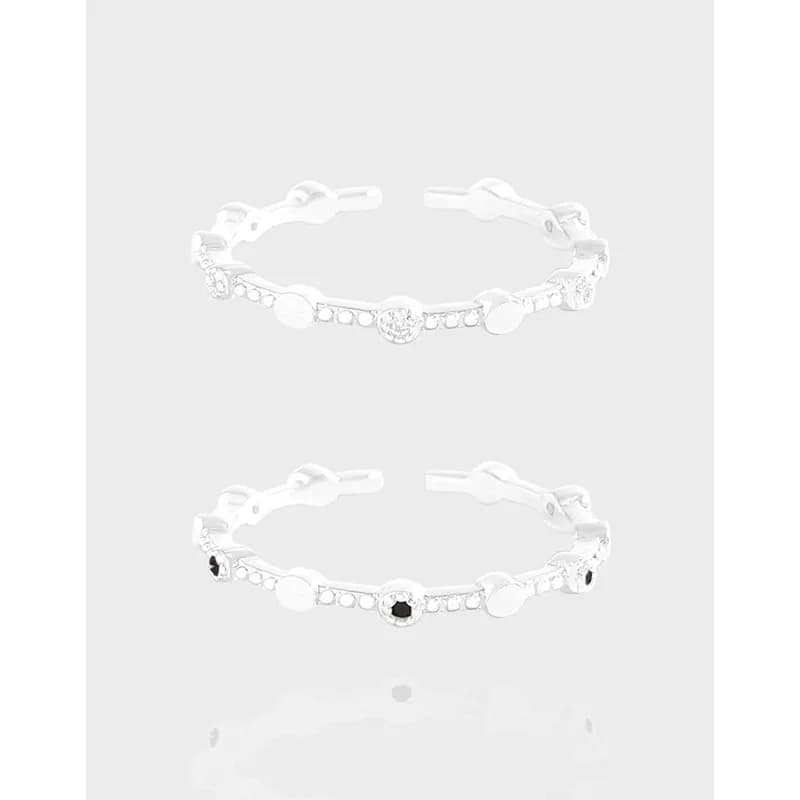 Polished sterling silver ring with beaded discs and pavé stones shown in a stackable, everyday design.